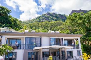 a house with a mountain in the background at Kolibri Holiday Apartments in Victoria