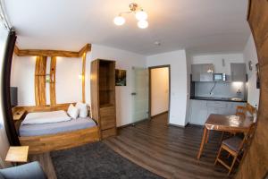 a bedroom with a bed and a table in a room at LuPartment in Ludwigshafen am Rhein