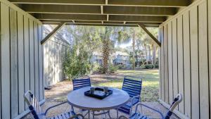 a patio with a table and chairs on a porch at The Village Palmetto Dunes in Hilton Head Island