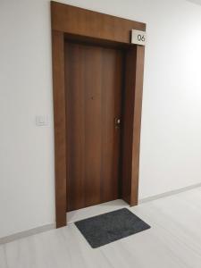 a wooden door in a room with a sign on it at Lux OPERA 2 in Banja Luka