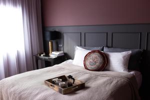 a bed with a tray on top of it at INNI - Boutique apartments in Hveragerði