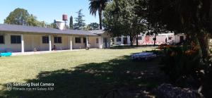 a house with a large yard in front of it at Posada de campo LA AMADA in San Pedro