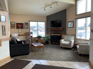 a living room with a couch and a fireplace at Days Inn by Wyndham Hinckley in Hinckley