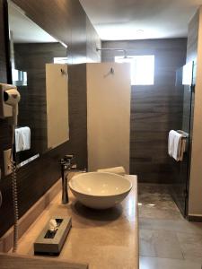 a bathroom with a large bowl sink on a counter at The Paramar Beachfront Boutique Hotel With Breakfast Included - Downtown Malecon in Puerto Vallarta