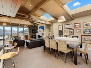 a dining room and living room with a table and chairs at Chambers City Centre Penthouse in Queenstown