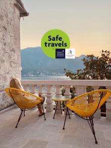 two chairs and a table on a patio with a view at Palazzo Radomiri Heritage Boutique Hotel in Kotor