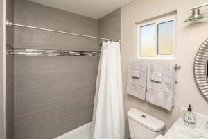 a bathroom with a shower curtain and a toilet at NEW! Family Lake Havasu Home Close To Off-Roading And London Bridge! in Lake Havasu City +19 photos