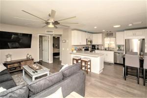 a living room with a couch and a kitchen at NEW! Family Lake Havasu Home Close To Off-Roading And London Bridge! in Lake Havasu City