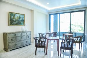 a dining room with a table and chairs and a dresser at Grand Fortune Hotel in Yerevan