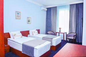Voodi või voodid majutusasutuse Grand Fortune Hotel toas