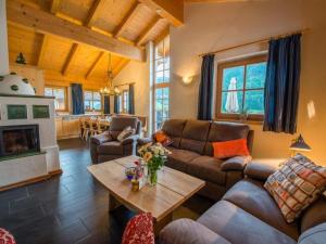 a living room with couches and a coffee table at Chalet in Austria near Ski Lift & Sauna in Wald im Pinzgau