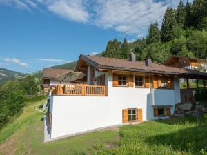 a house on a hill with a balcony at Chalet in Austria near Ski Lift & Sauna in Wald im Pinzgau