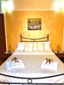 a bedroom with a bed with two towels on it at LA TERRAZZA SUL CORSO City Center in Agrigento
