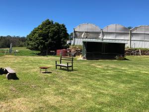 a park with a bench and a table in the grass at Walsh Farm Shepherd’s Rest in Milton