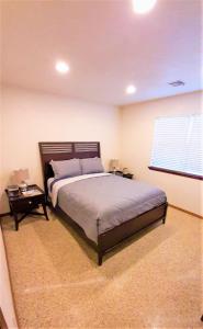 a bedroom with a large bed and a window at Near to OUHSC Hospitals-Garage Studio in Oklahoma City