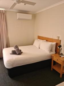 a bedroom with a bed with a stuffed animal on it at Henry's Quirindi in Quirindi