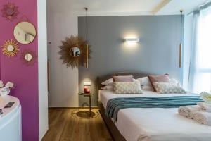 a bedroom with two beds and a mirror on the wall at 4 Star Suite SPA - Self Check-In in Bologna