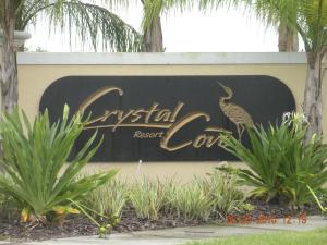 a sign for a resort with a peacock on it at CozyKey Vacation Rentals - Crystal Cove in Kissimmee