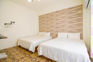 Cama o camas de una habitación en 馬公港精品旅宿包棟烤肉附設租車