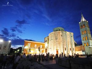 a group of people standing in front of a building at Peninsula Luxury Rooms in Zadar