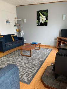 a living room with a couch and a coffee table at The Dunes Beach House in Goolwa