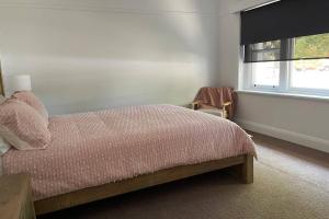 a bedroom with a bed and a window at Hazeldene - The Best Location In Town! in Myrtleford
