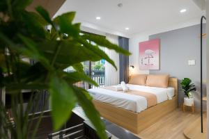 a bedroom with a bed and a balcony at Cozrum Homes Ambera House in Ho Chi Minh City