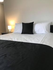 a large white bed with two pillows on it at Guiding Star Motel & Hotel in Brooklyn