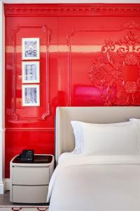 a bedroom with a red headboard and a white bed at Jin Bei Palace Hotel in Sihanoukville