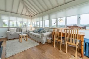 a living room with a couch and a table and chairs at Westerley in Portreath