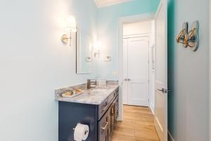 a bathroom with a blue counter and a sink at West Side Cottage #OO in Gulf Shores