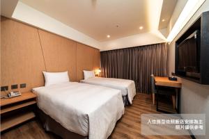 Postel nebo postele na pokoji v ubytování Fish Hotel Kaohsiung