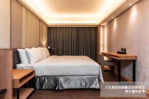 Postel nebo postele na pokoji v ubytování Fish Hotel Kaohsiung