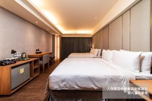 Postel nebo postele na pokoji v ubytování Fish Hotel Kaohsiung
