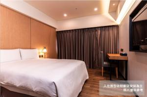 Postel nebo postele na pokoji v ubytování Fish Hotel Kaohsiung