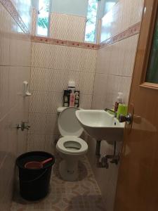 a small bathroom with a toilet and a sink at SINGSON RESIDENCE 