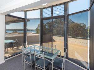 a room with a table and chairs on a balcony at The Brighton Apartments in Toronto