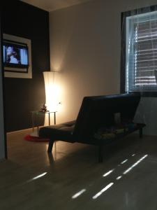 a living room with a couch and a lamp at Apartments Stakic in Krvavica
