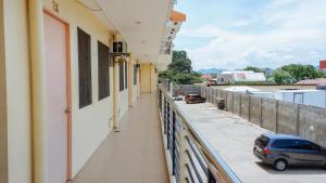 a balcony of a building with a car parked on it at RedDoorz Plus near Talisay Town Center in Talisay