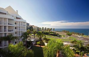 Blick auf ein Gebäude und eine Straße mit Palmen in der Unterkunft Osprey Apartments in Mooloolaba