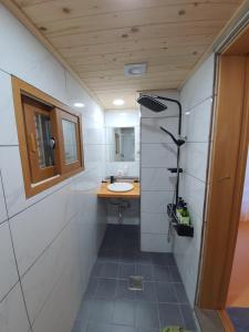 a small bathroom with a sink and a mirror at SiEunJae in Gyeongju