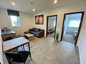 a living room with a couch and a table at Apartmány Pelhřimov in Pelhřimov