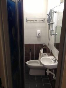 a bathroom with a toilet and a sink at NGS Hotel in Kuantan