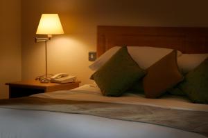 A bed or beds in a room at Deebert House Hotel