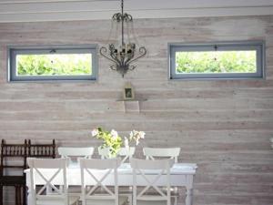 a dining room with a white table and white chairs at Gîte de la Colombière in La Grande-Verrière