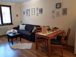 a living room with a couch and a table at Borovets Holiday Homes in Borovets