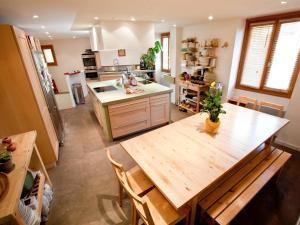 a kitchen with a large wooden table and a kitchen with a counter at The FrogS' House - Yoga Retreat in Saint-Jeannet