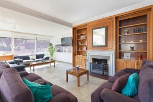 Una sala de estar con sofás y chimenea. en Villa Arenas, en Playa de Palma