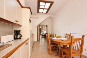 a kitchen and dining room with a table and chairs at Ca na Miquela in El Arenal +18 photos