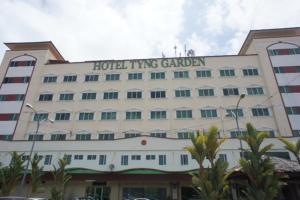 a hotel building with a sign that reads hospitality garden at Tyng Garden Hotel in Sandakan